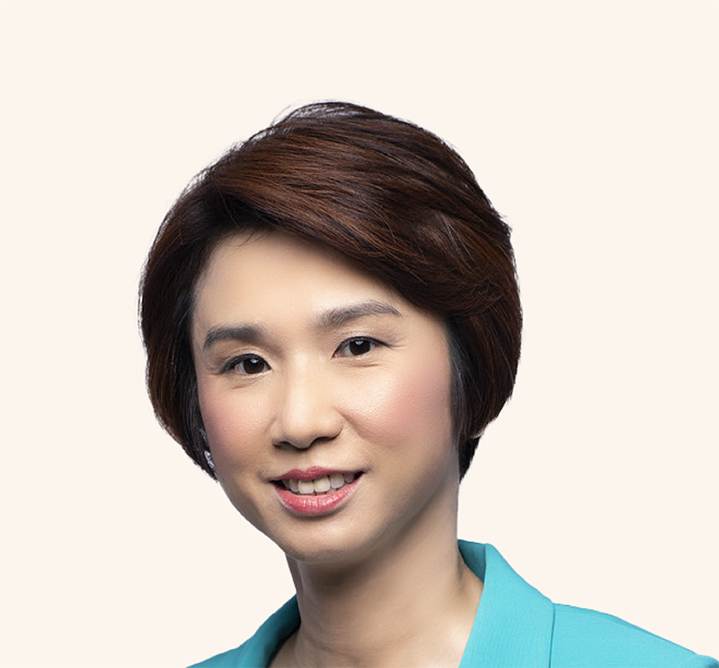 Senior Minister of State Low Yen Ling in teal blazer, smiling against light background.
